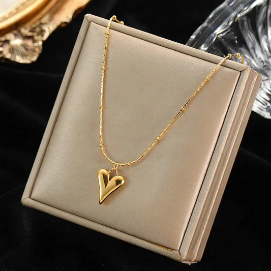 Goldene Y-Halskette mit Herzanhänger und kleinen Kügelchen aus 3-fach vergoldetem Edelstahl in eleganter Geschenkbox